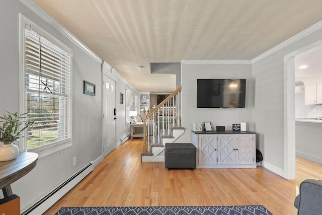 living room with crown molding, light wood-style flooring, baseboards, a baseboard heating unit, and stairway