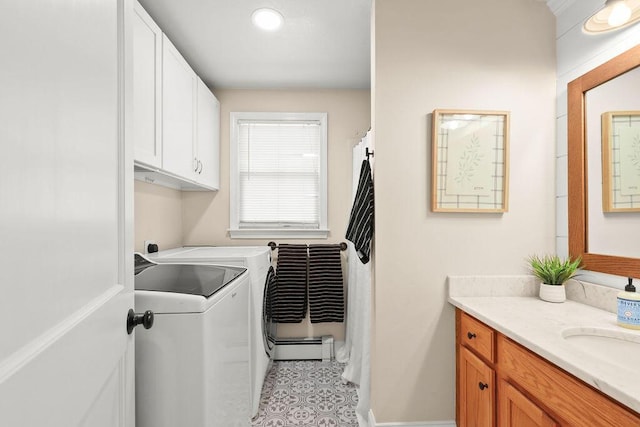washroom featuring a sink, cabinet space, and washing machine and clothes dryer