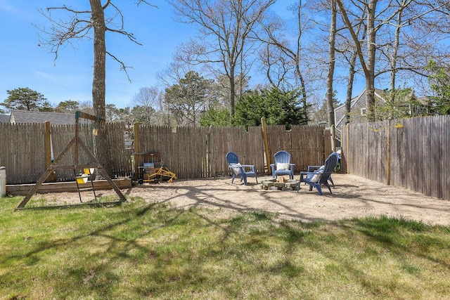 view of yard featuring a patio, a fire pit, and a fenced backyard