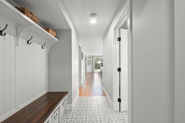 mudroom featuring tile patterned flooring and baseboards