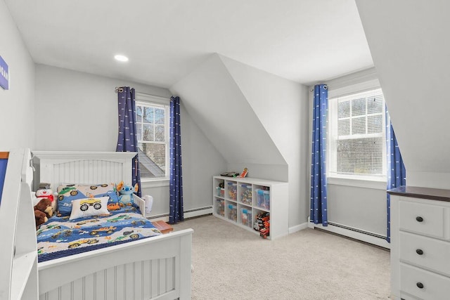 bedroom with a baseboard heating unit, baseboards, vaulted ceiling, and carpet