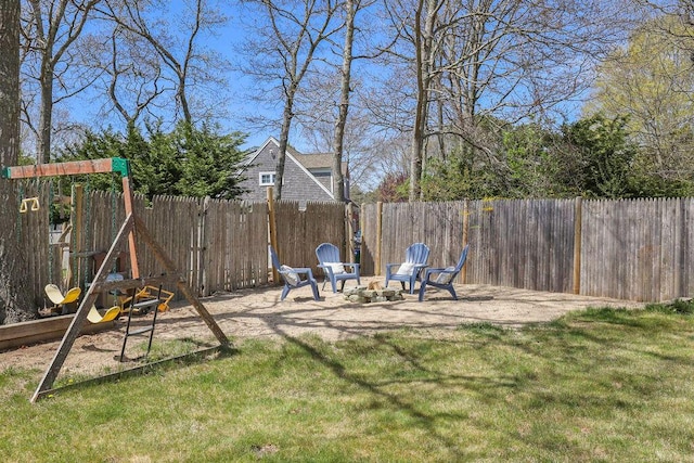 view of yard featuring a playground, fence private yard, and a patio area