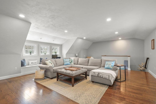 living room with baseboards, vaulted ceiling, and wood finished floors