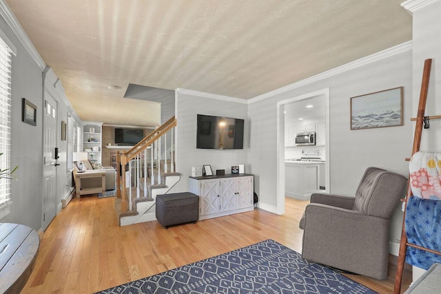 living area with stairs, crown molding, and light wood-type flooring