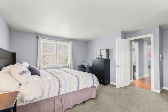 carpeted bedroom featuring baseboards