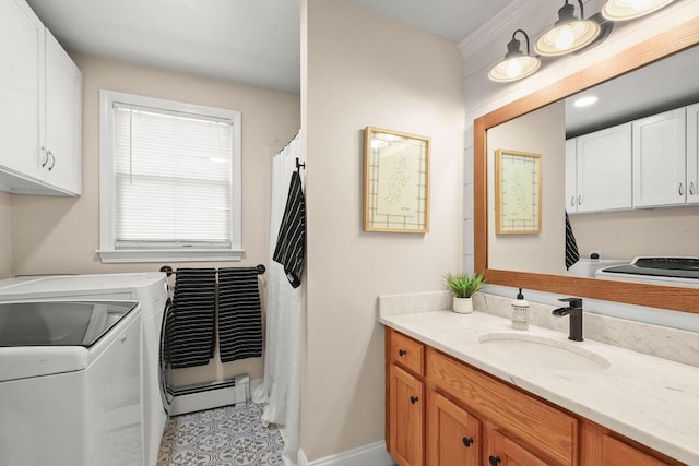bathroom with vanity, washer and clothes dryer, and baseboards