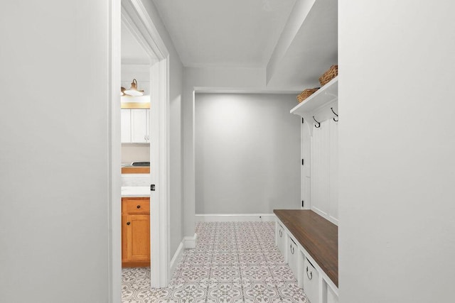 mudroom featuring baseboards and light tile patterned flooring