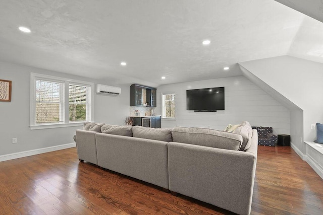 living room featuring recessed lighting, baseboards, a wall mounted AC, and dark wood-style floors