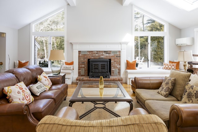 living room with beam ceiling, a wealth of natural light, a wall unit AC, and hardwood / wood-style flooring