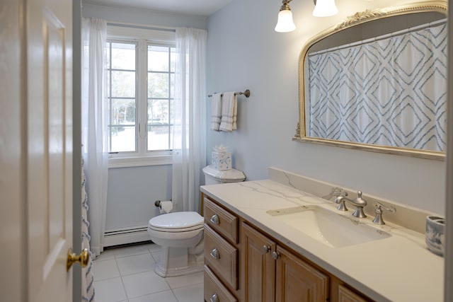 bathroom with baseboard heating, tile patterned floors, a healthy amount of sunlight, and vanity