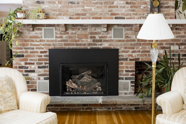 interior details featuring hardwood / wood-style floors and a fireplace