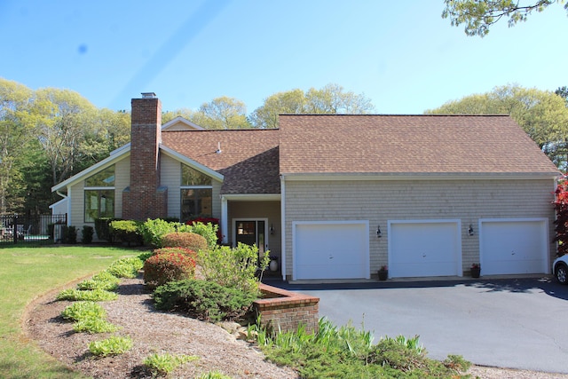 98 Bunker Hill Rd, Osterville, MA 02655 - view of front of property with a chimney, a garage, a shingled roof, and driveway
