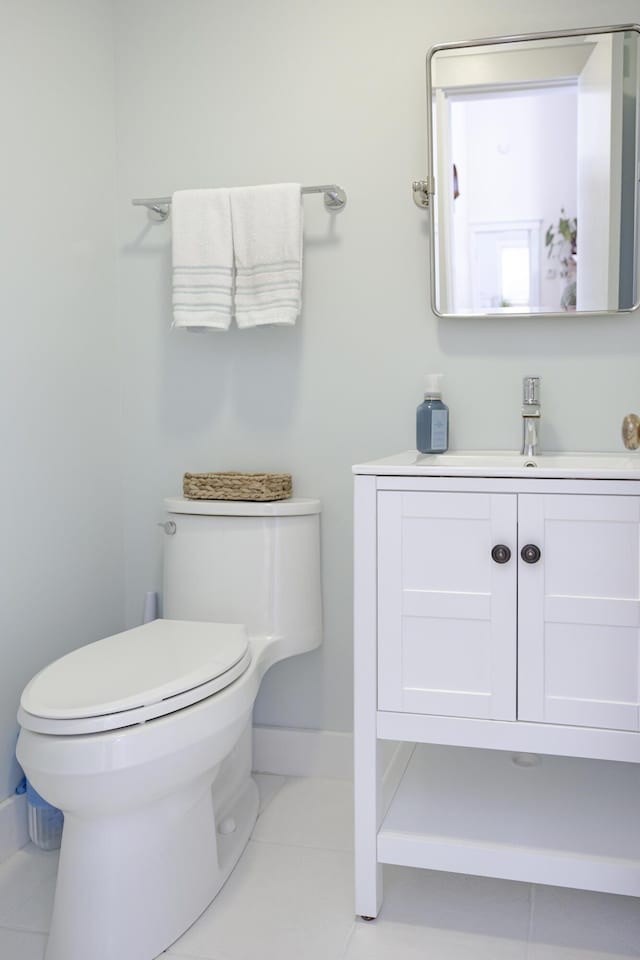 bathroom featuring vanity, tile patterned floors, and toilet