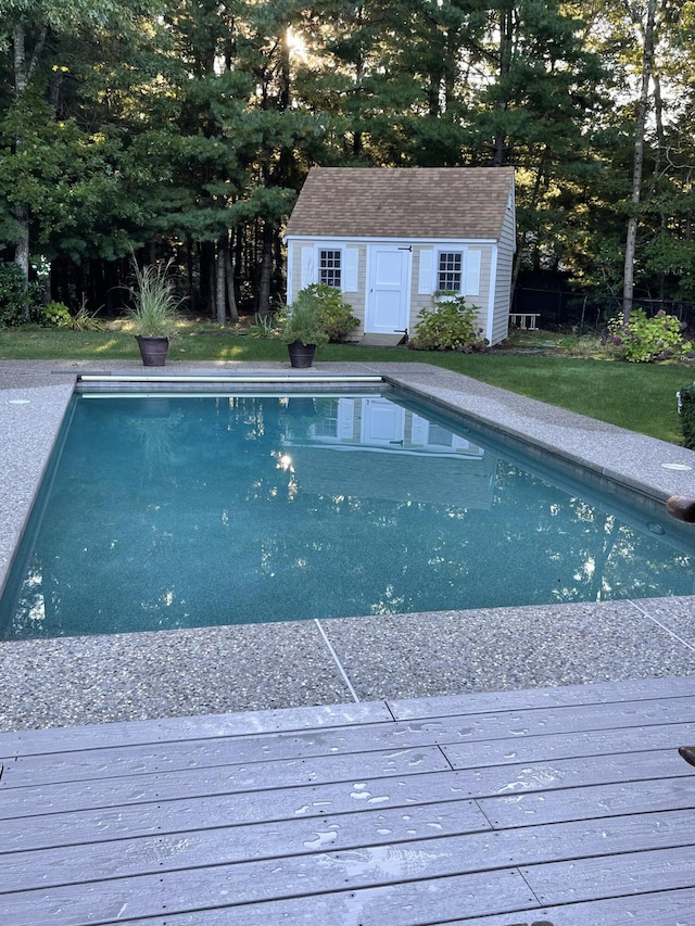 view of pool with an outbuilding