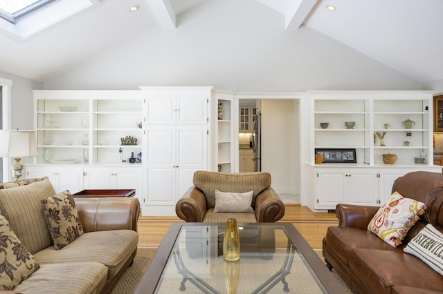 living room with beamed ceiling, light hardwood / wood-style flooring, high vaulted ceiling, and a skylight