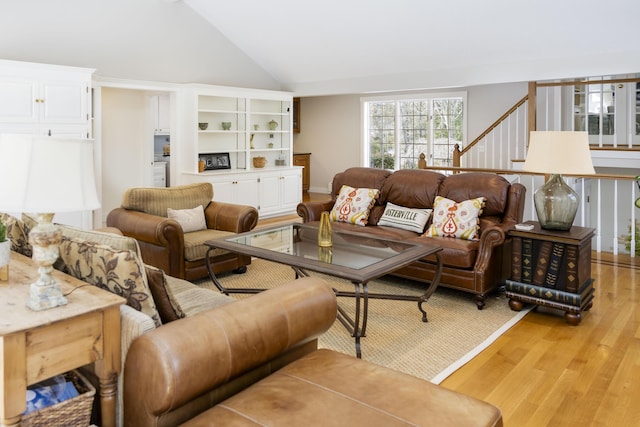 living room with lofted ceiling and light hardwood / wood-style floors