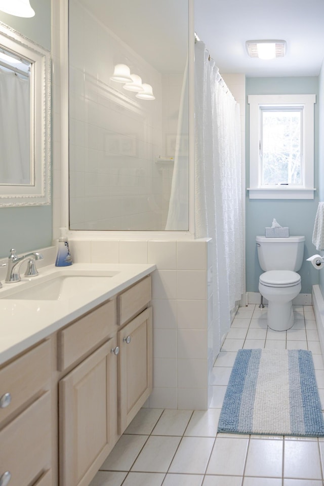 bathroom with vanity, toilet, and tile patterned flooring