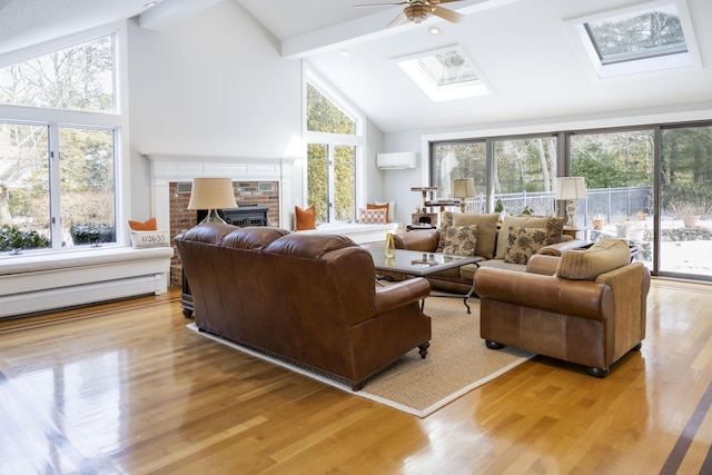 living room featuring beamed ceiling, a wall mounted AC, light wood-type flooring, and a skylight