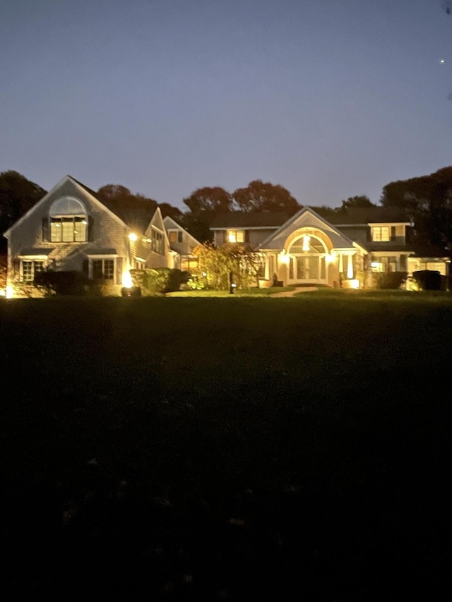 view of back house at dusk