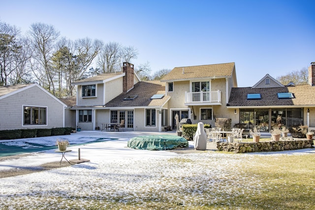 back of property featuring a covered pool and a patio area