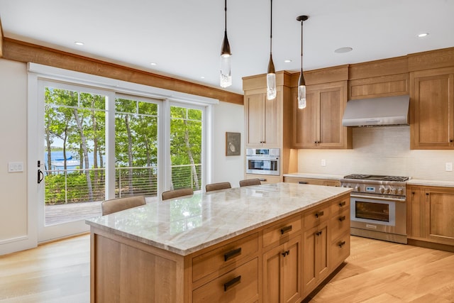2 Bridge St, East Falmouth, MA 02536 - kitchen with stainless steel appliances, wall chimney exhaust hood, plenty of natural light, tasteful backsplash, and recessed lighting