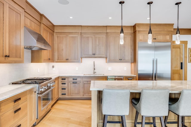 2 Bridge St, East Falmouth, MA 02536 - kitchen with extractor fan, a sink, high quality appliances, a kitchen breakfast bar, and tasteful backsplash