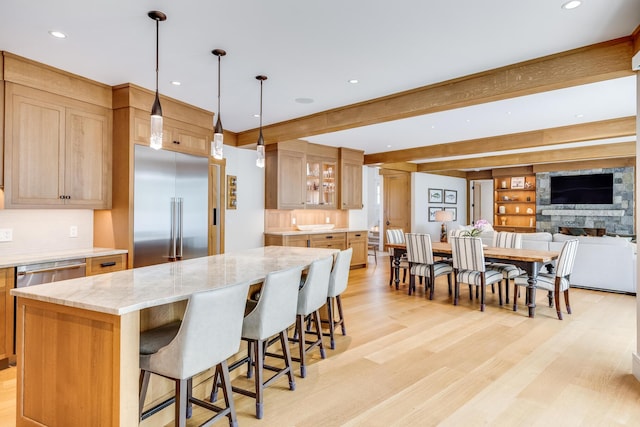 2 Bridge St, East Falmouth, MA 02536 - kitchen featuring stainless steel appliances, a large island, backsplash, light wood-style flooring, and recessed lighting