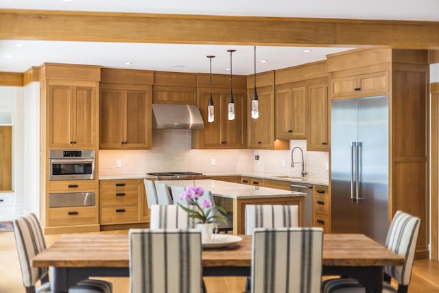 2 Bridge St, East Falmouth, MA 02536 - kitchen with appliances with stainless steel finishes, range hood, a warming drawer, a sink, and a center island