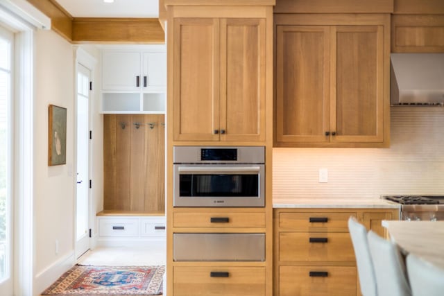 2 Bridge St, East Falmouth, MA 02536 - kitchen featuring stainless steel appliances, light countertops, decorative backsplash, wall chimney exhaust hood, and a warming drawer