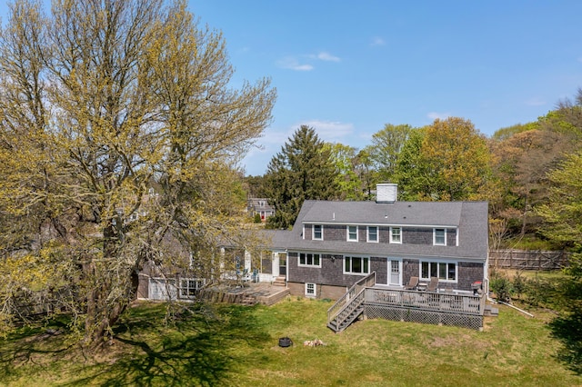 back of house with a wooden deck and a yard