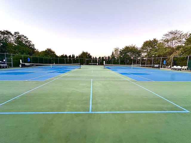 view of sport court featuring fence