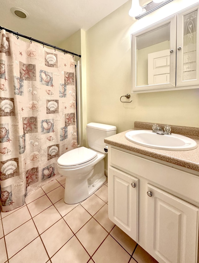 bathroom featuring vanity, tile patterned floors, toilet, and a shower with curtain