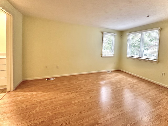 empty room with light hardwood / wood-style floors