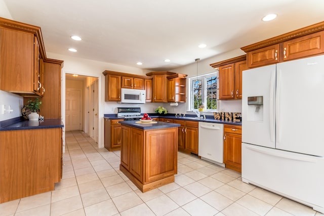 kitchen featuring white appliances, a center island, open shelves, dark countertops, and brown cabinetry