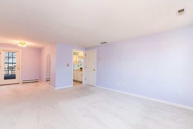 spare room featuring visible vents, baseboards, and light colored carpet