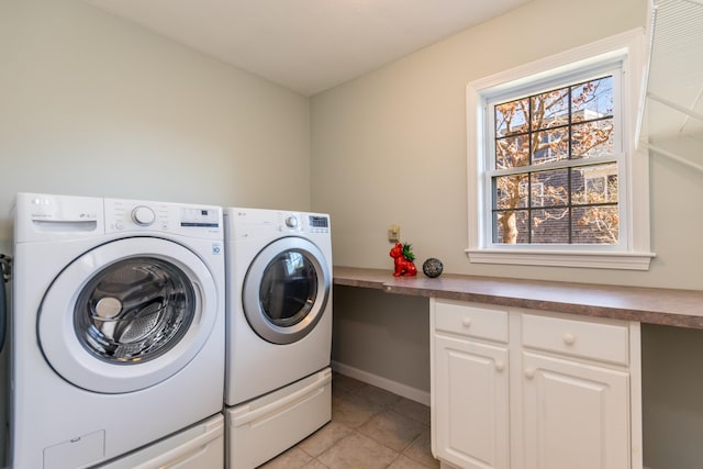 laundry room with laundry area, light tile patterned floors, baseboards, and washer and clothes dryer