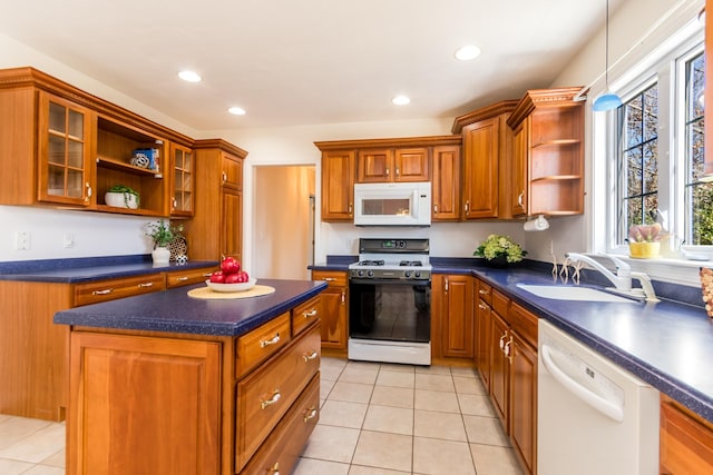 kitchen featuring white appliances, a sink, open shelves, and dark countertops