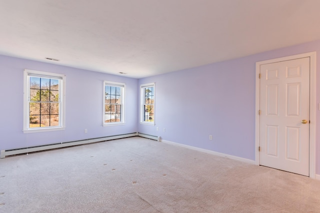 carpeted empty room with baseboard heating, baseboards, and visible vents