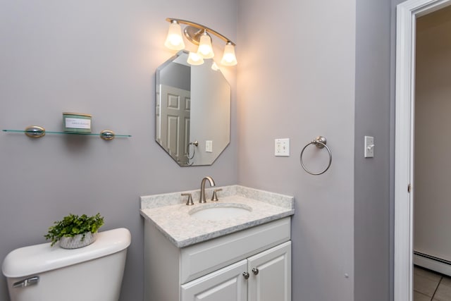half bath featuring toilet, a baseboard radiator, vanity, and tile patterned floors