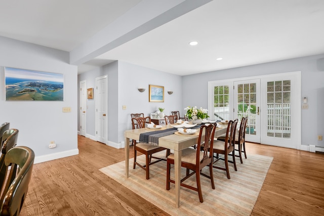 dining area with light wood-type flooring, recessed lighting, and baseboards