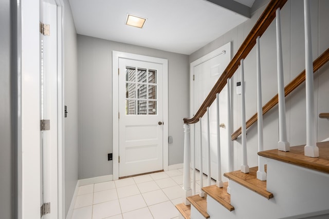 entrance foyer with stairs and baseboards