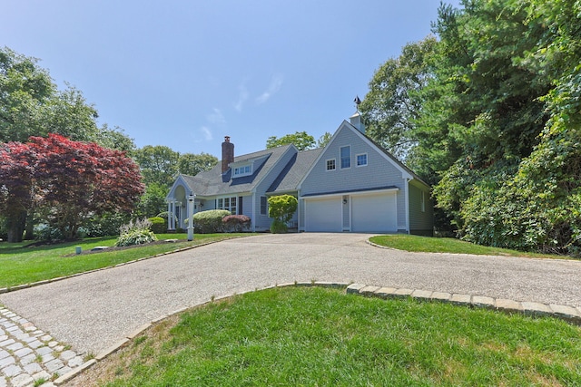 67 Sea Meadow Cir, Centerville, MA 02632 - view of front of property with asphalt driveway, a front lawn, and a chimney