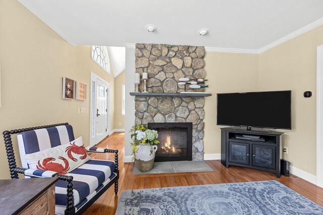 67 Sea Meadow Cir, Centerville, MA 02632 - living room with a stone fireplace, crown molding, and wood finished floors
