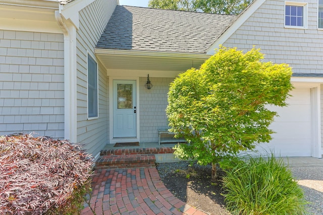 67 Sea Meadow Cir, Centerville, MA 02632 - view of exterior entry with a shingled roof, a garage, and covered porch