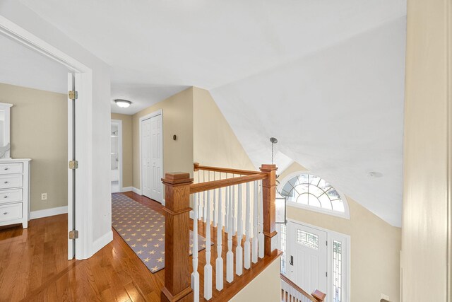67 Sea Meadow Cir, Centerville, MA 02632 - corridor with wood finished floors, lofted ceiling, and an upstairs landing