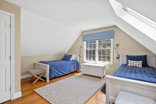 67 Sea Meadow Cir, Centerville, MA 02632 - bedroom with wood finished floors, radiator heating unit, and lofted ceiling