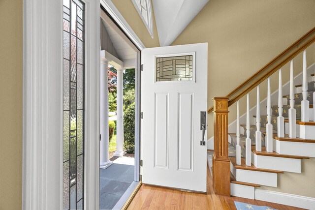 67 Sea Meadow Cir, Centerville, MA 02632 - foyer with wood finished floors, vaulted ceiling, and stairway