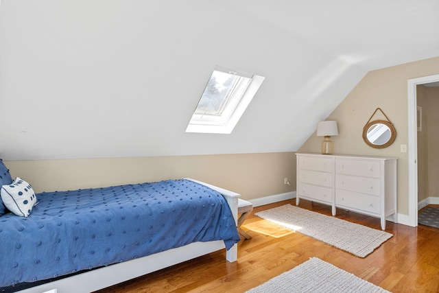 67 Sea Meadow Cir, Centerville, MA 02632 - bedroom featuring a skylight, vaulted ceiling, and wood finished floors