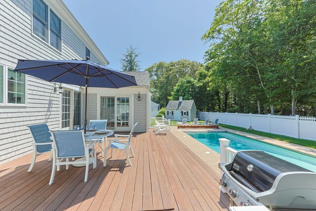 67 Sea Meadow Cir, Centerville, MA 02632 - wooden terrace with outdoor dining space, a fenced backyard, a shed, and a grill
