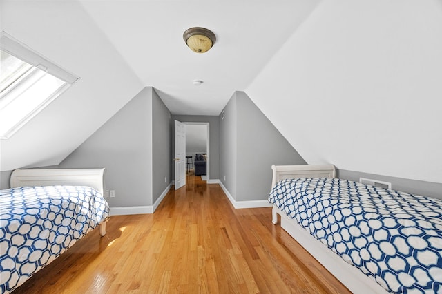 67 Sea Meadow Cir, Centerville, MA 02632 - bedroom with wood finished floors, vaulted ceiling, and a skylight